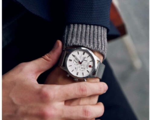 How to succeed in an office job: A person is checking their watch. It's good to show up on time at work.