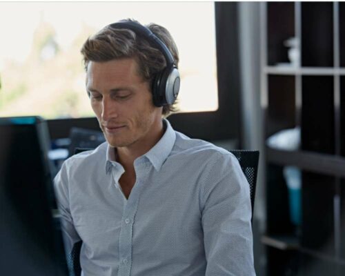 How to be productive in the office: Using headphones while working can be great to block off distractions.